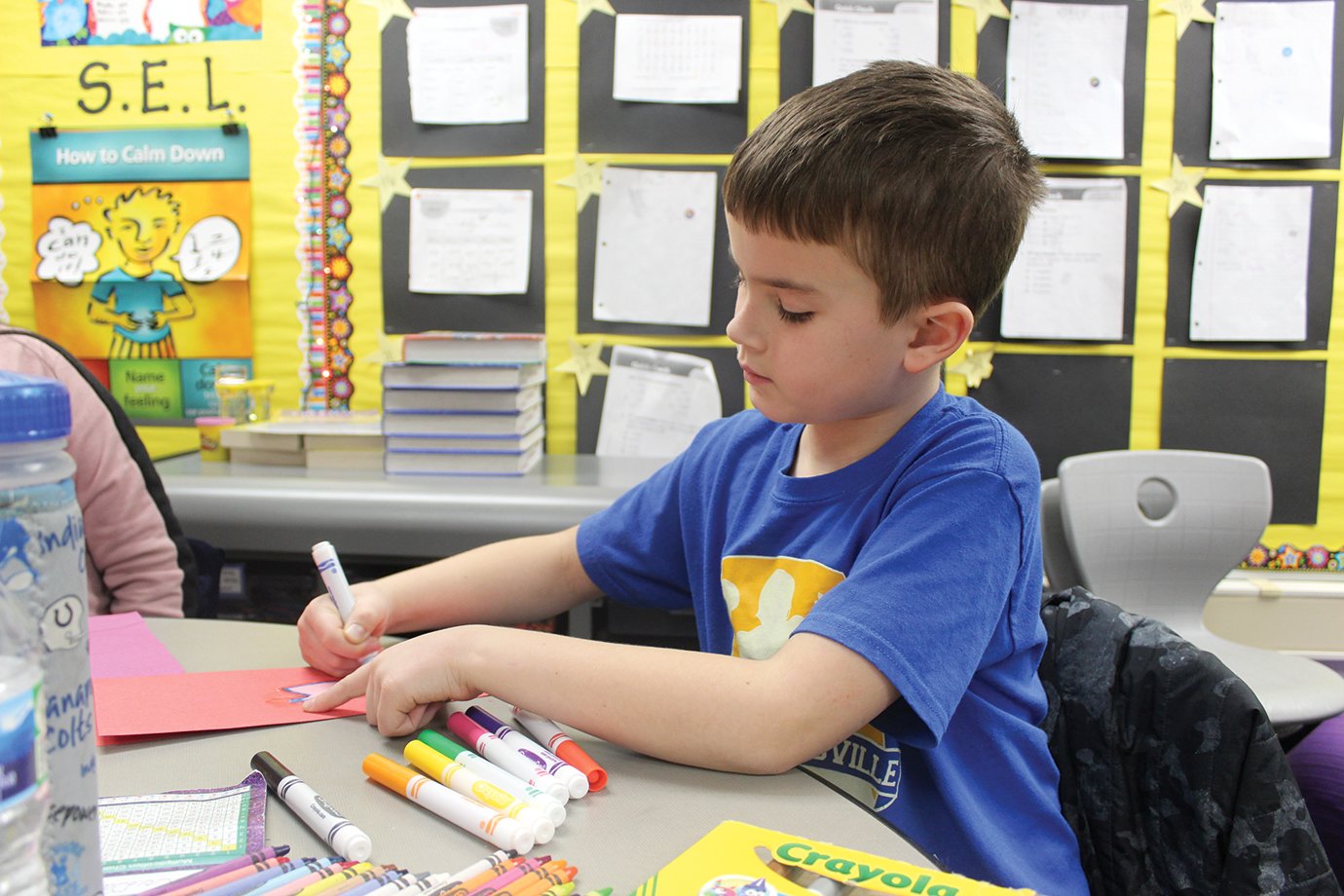 Nicholson third-grade student Conner White breaks out the markers Thursday in celebration of Valentine’s Day.